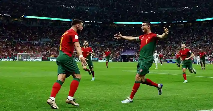 Portugal progress to the World Cup round of 16 with a Fernandes double.